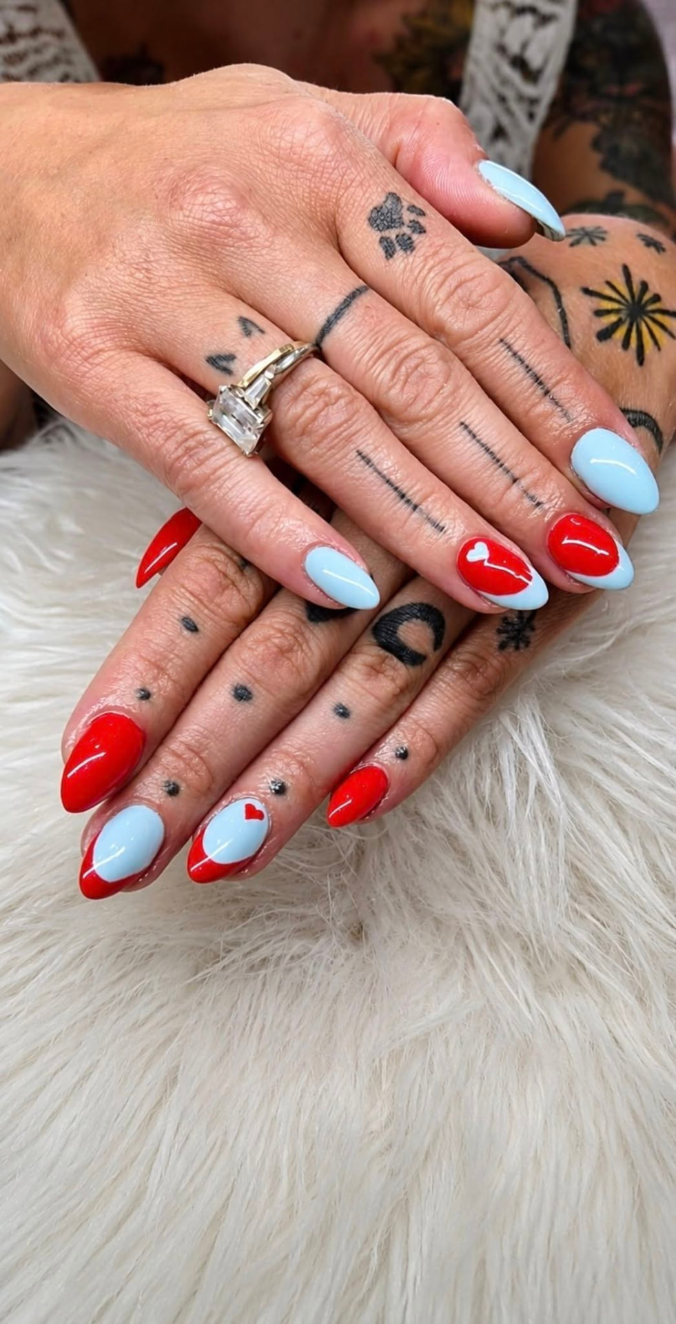 Red and baby-blue nail art with heart detail