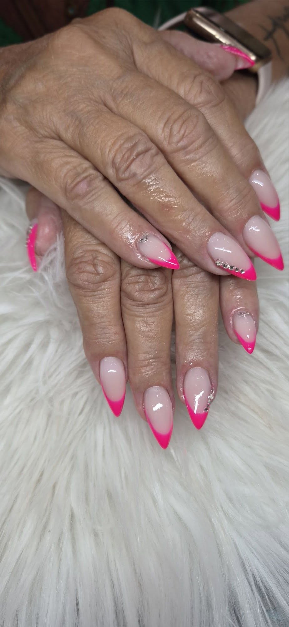 Pink French tip nails with crystal accents